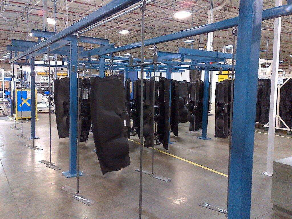 Overhead conveyor line carrying parts through a plant