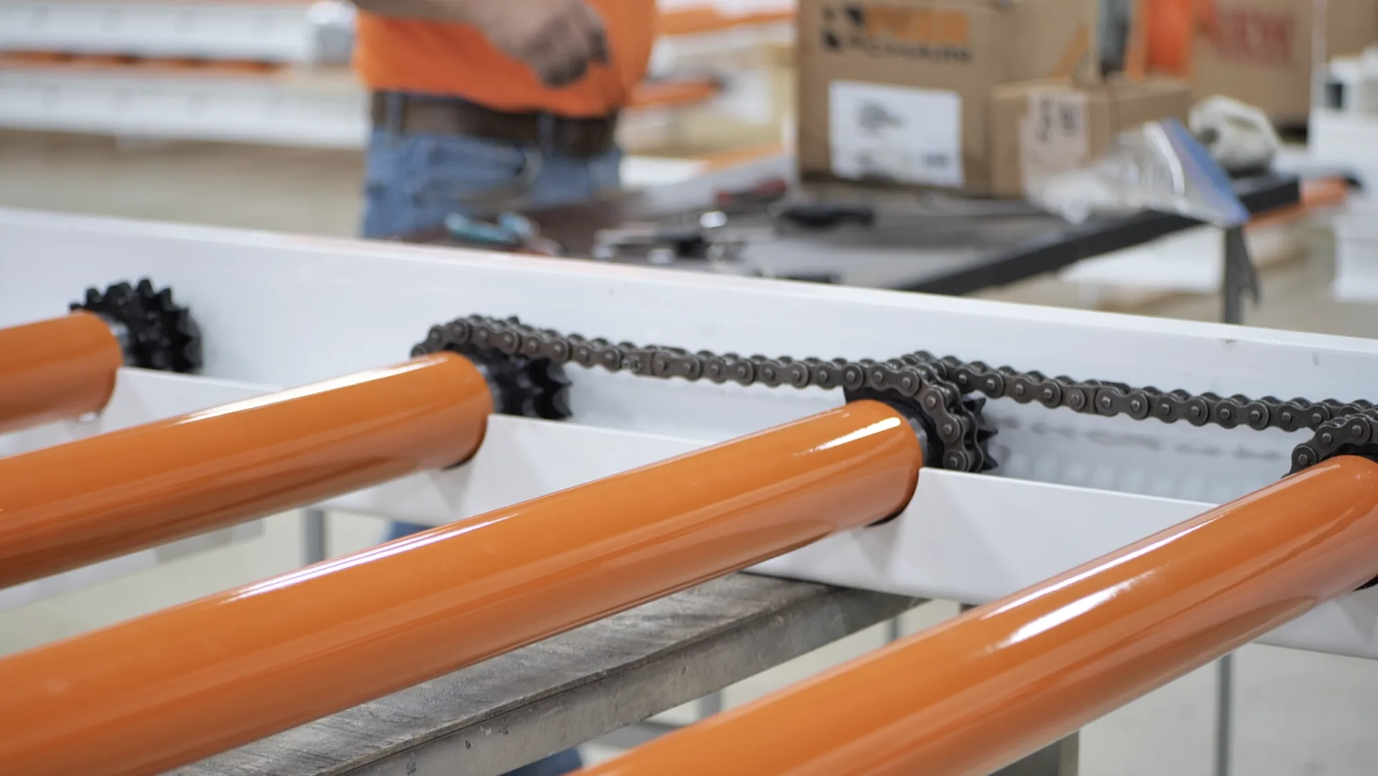 Chain drive and rollers on a conveyor section